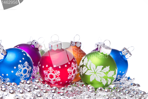 Image of christmas balls with snowflake symbols