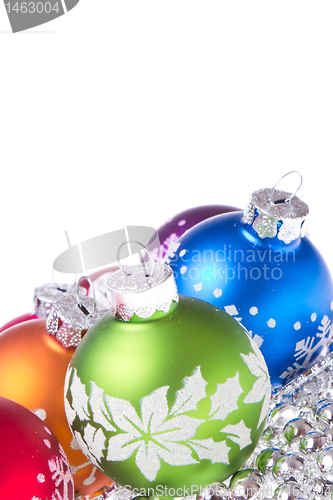 Image of christmas balls with snowflake symbols