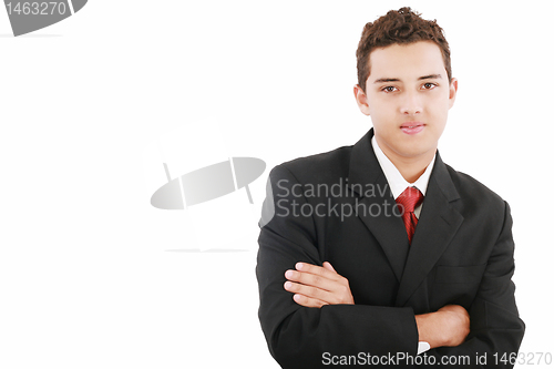 Image of Young business man standing against the wall with crossed arms 