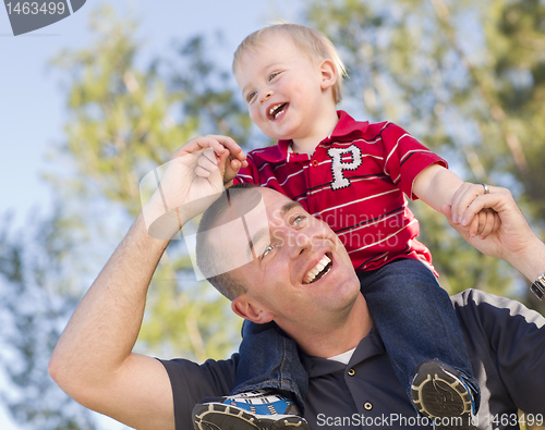 Image of Young Laughing Father and Child Piggy Back