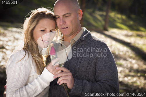 Image of Attractive Young Couple with Rose