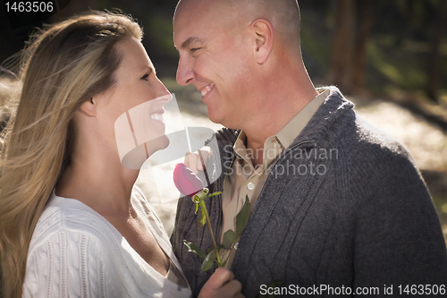 Image of Attractive Young Couple with Rose