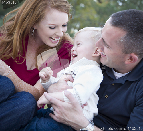 Image of Attractive Young Parents Laughing with Child Boy in Park