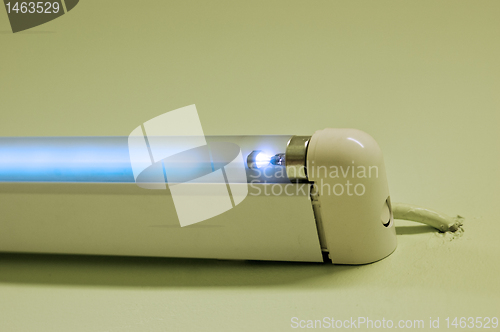 Image of Fluorescent lamp shining on white studio ground