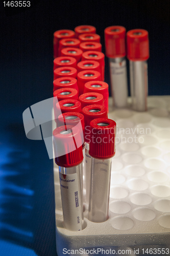 Image of Red test tubes placed at curved lines