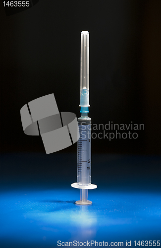 Image of Empty medical syringe standing head up