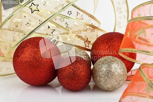 Image of Gold and red Christmas baubles.
