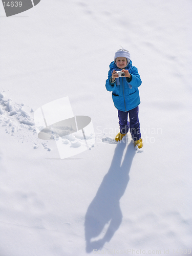 Image of Young girl with photocamera on the snow field