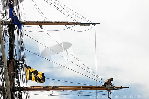 Image of Sailor working on tall ship's mast