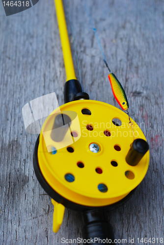 Image of fishing rod with yellow reel 