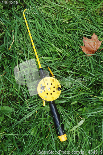 Image of fishing rod with yellow reel  