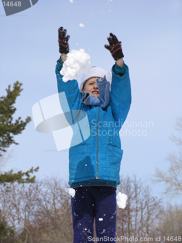 Image of Young girl playing with snow