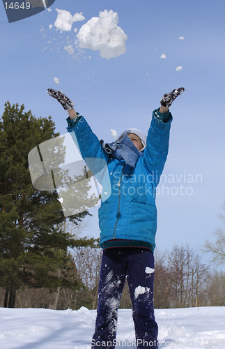 Image of Young girl playing with snow