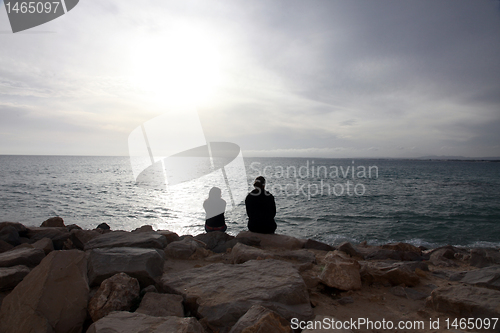 Image of Two girls sit on the beach