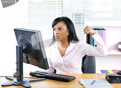 Image of Angry black businesswoman at desk