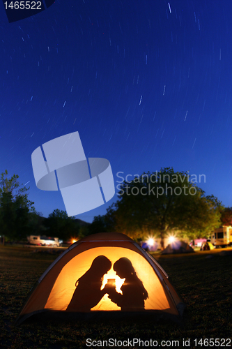 Image of Children Camping at Night in a Tent
