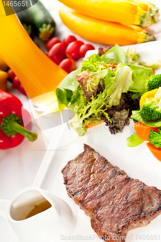 Image of juicy BBQ grilled rib eye ,ribeye steak and vegetables