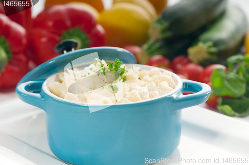 Image of mac and cheese on a blue little clay pot