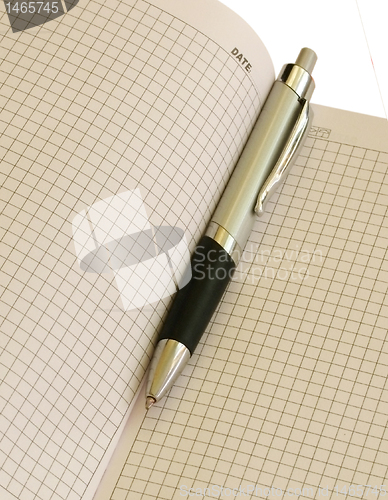 Image of pen in a notepad