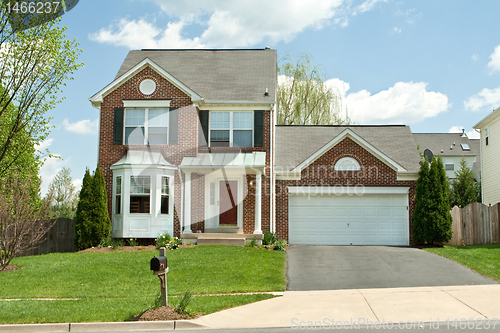 Image of Brick Single Family House in Suburban Maryland, USA, Blue Sky