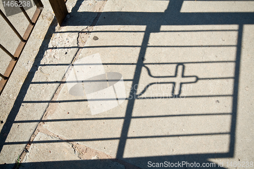 Image of Shadow of a Gate with a Cross in it