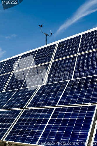 Image of PV Solar Panel Array Against Blue Sky Anemometer