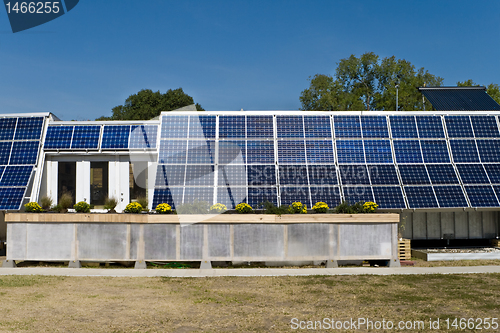 Image of PV Solar Panel Array Mounted on Home Blue Sky