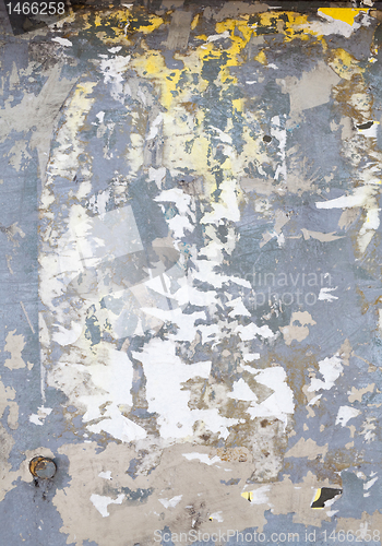 Image of Full Frame Metal Surface Covered Torn Poster Scraps