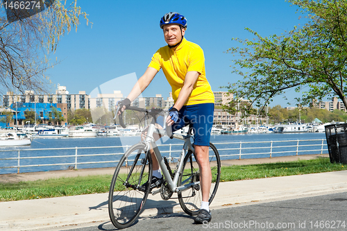 Image of Senior Man With Helmet Sitting on a Bicycle