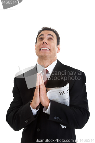 Image of Businessman Holding Business Section Newspaper Looking Up Prayin