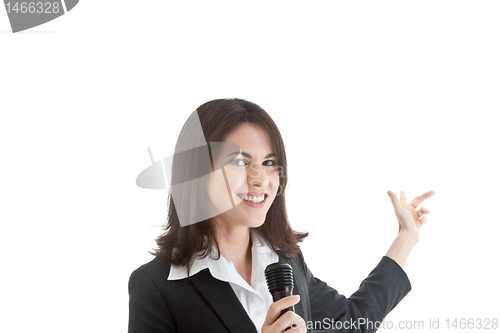 Image of Caucasian Woman Holding Microphone Pointing Behind White Backgro