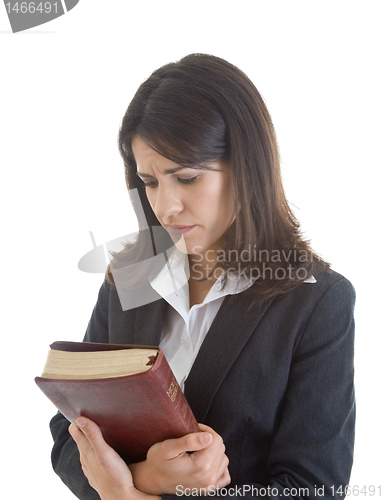 Image of Worried Caucasian Woman Holding Bible Looking Down Praying White