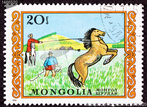 Image of Canceled Mongolian Postage Stamp Men Capturing Lassoing Wild Hor