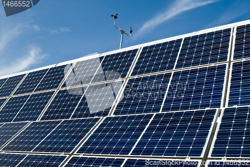 Image of PV Solar Panel Array Against Blue Sky Anemometer