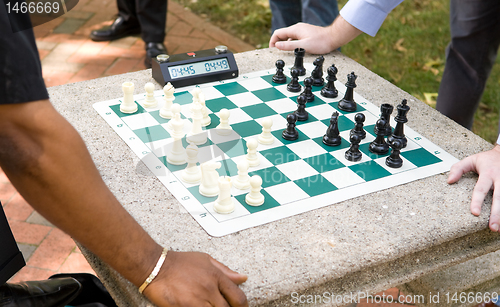 Image of Two Players Play Timed Chess Game in a Park 
