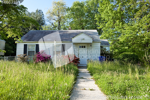 Image of XXXL Front View Abandoned Foreclosed Cape Cod Home Long Grass