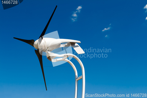 Image of Home Sized Windmill Wind Turbine Isolated on Blue Sky        