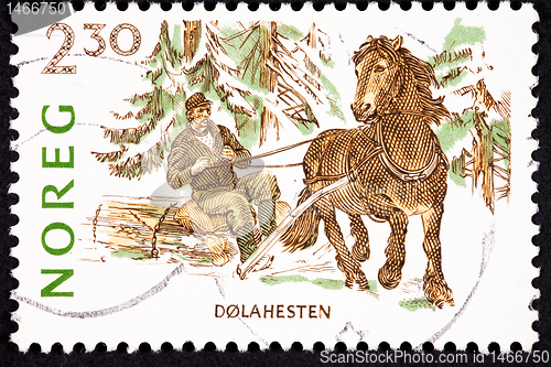 Image of Canceled Norway Postage Stamp Dales Pony Pulling Man Log, Snow