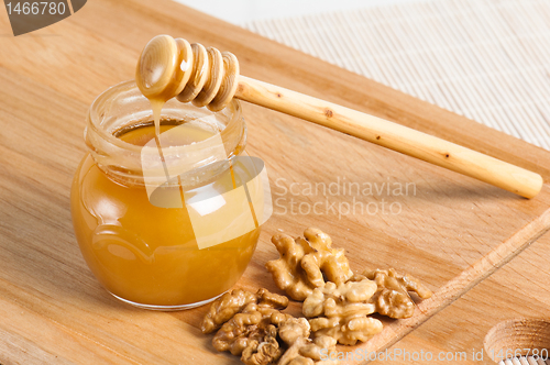Image of bee honey with walnuts