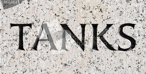 Image of Word "Tanks" Carved in Gray Granite Stone