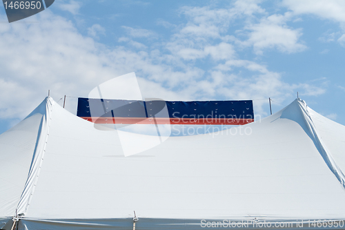 Image of Banner Between Two Tent Poles Blue Sky