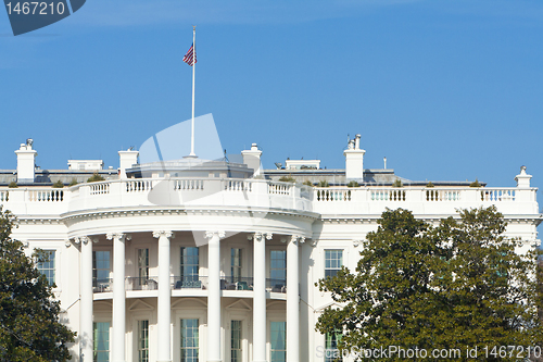 Image of South Side of White House, American Flag, Blue Sky