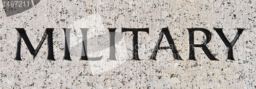 Image of Word "Military" Carved in Gray Granite Stone