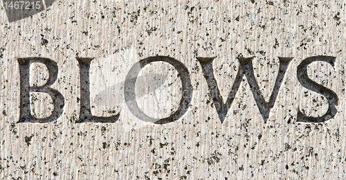 Image of Word "Blows" Carved in Gray Granite Stone