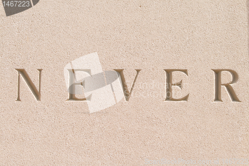 Image of Word "Never" Carved in Sandstone Stone