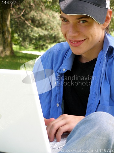 Image of Teenager outside happy with a laptop closeup
