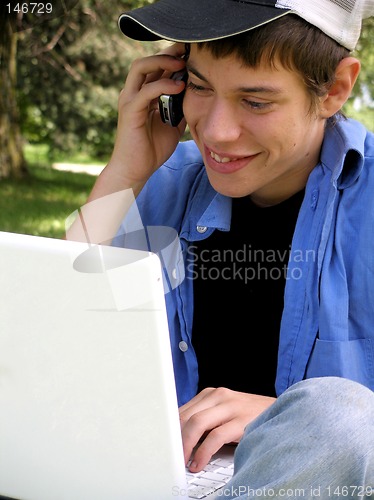 Image of Teenager with a laptop and cellular