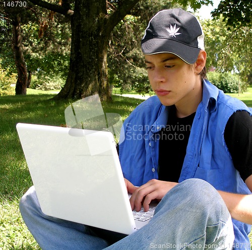 Image of Teenager outside with a laptop