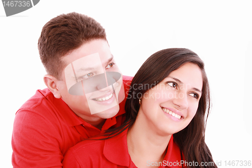 Image of Portrait of a happy couple hugging each other and looking away -
