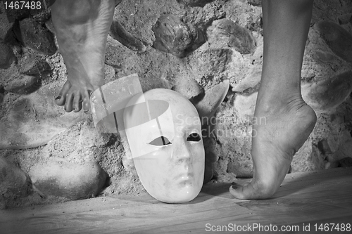 Image of Female feet above a mask